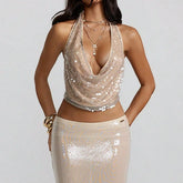 Woman wearing a sparkly gold top and skirt